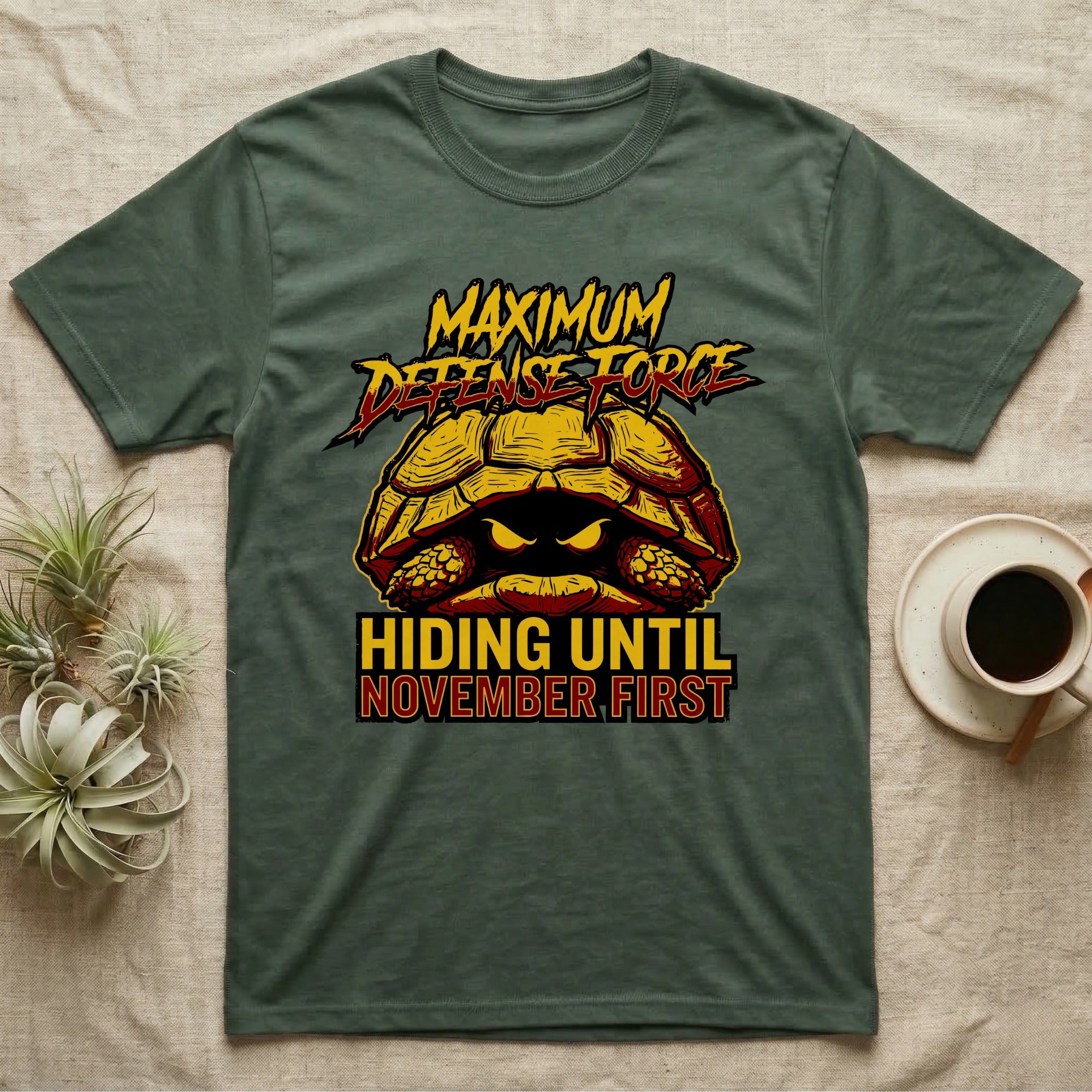 Tortoise Maximum Defense Force T-Shirt in Military Green — Metal graphic of a tortoise glaring from its shell, "Maximum Defense Force, Hiding Until November First."