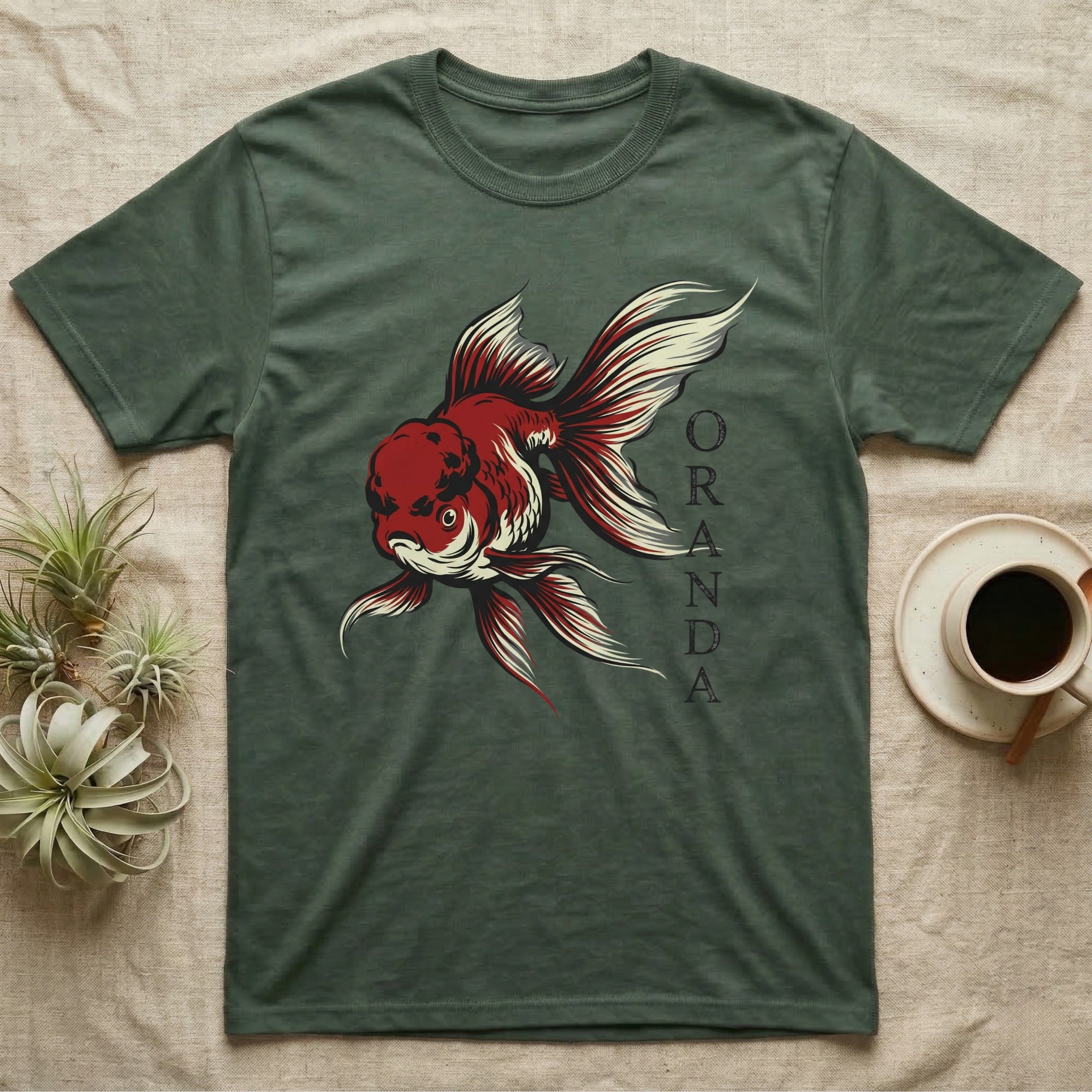 Green t-shirt with red and white goldfish illustration and ORANDA text.