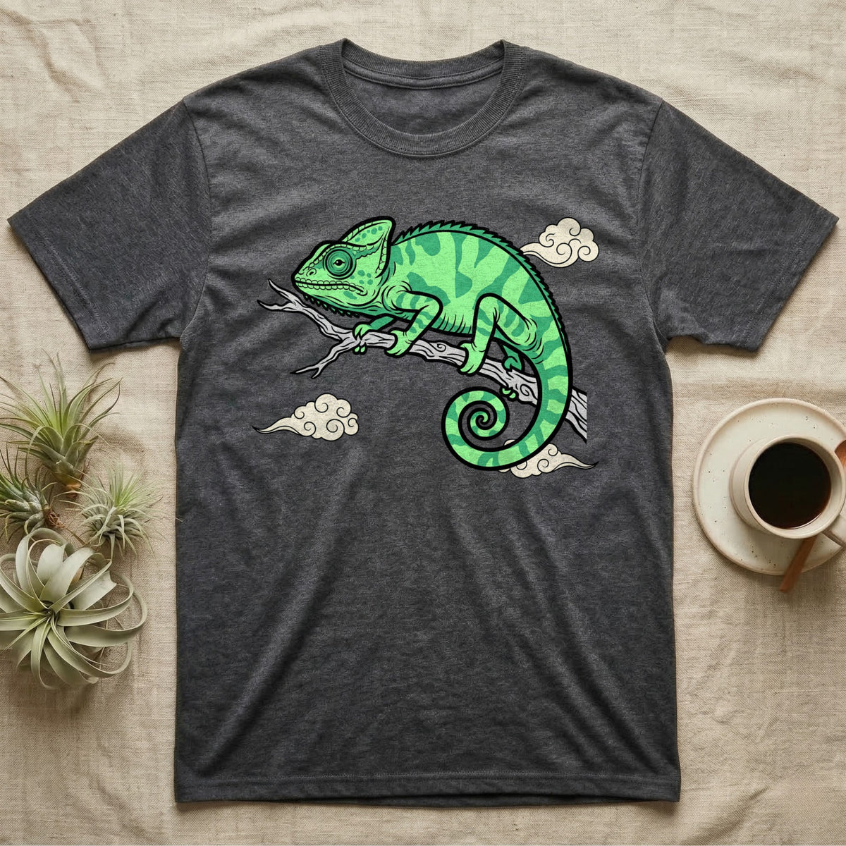 Dark grey t-shirt featuring a cartoon green chameleon on a branch.