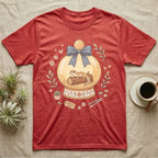 T-shirt with a leopard gecko in a snow globe with floral accents and "Home is here" tag.