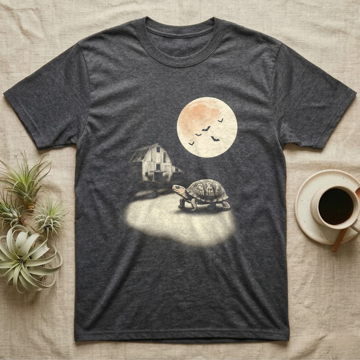 Box Turtle Moonlight T-Shirt in Dark Heather — An eastern box turtle mid-step across a moonlit yard, a derelict barn behind it and a large cream moon high right.
