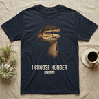Photographic mugshot of a ball python staring down the lens above the distressed hook I Choose Hunger, on strike. — shown on a Navy tee.