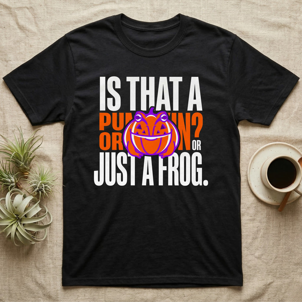 Frog Jack-O'-Lantern Illusion T-Shirt in Black — Typographic graphic of an orange frog doubling as a jack-o'-lantern, "Is That a Pumpkin? Or Just a Frog."