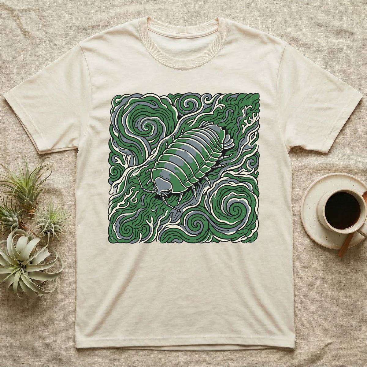 Cream t-shirt with a green, stylized illustration of an isopod.