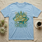 Light blue t-shirt with geometric crested gecko design and city skyline.