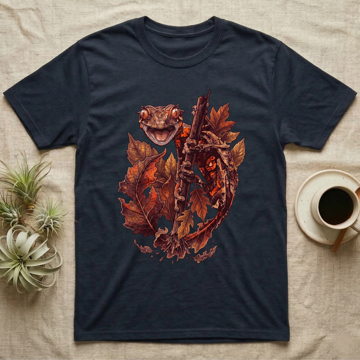Satanic Leaf-Tailed Gecko Autumn T-Shirt in Navy — Painted illustration of a satanic leaf-tailed gecko gripping a bare stem among dried autumn leaves in rust and amber, no on-shirt text.