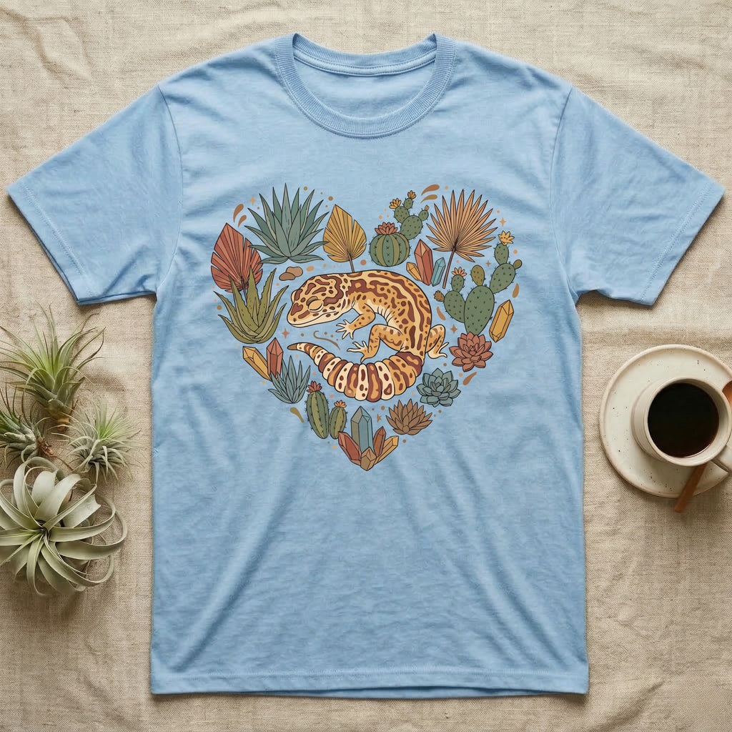 Light blue t-shirt with a heart-shaped design of a gecko and succulents.