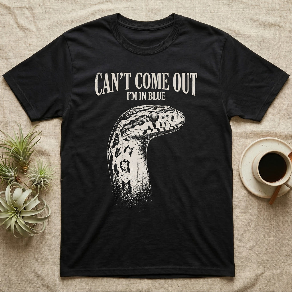 Corn Snake Shed T-Shirt in Black — Gritty white print of a corn snake head with milky pre-shed eyes under CAN'T COME OUT, I'M IN BLUE, on black
