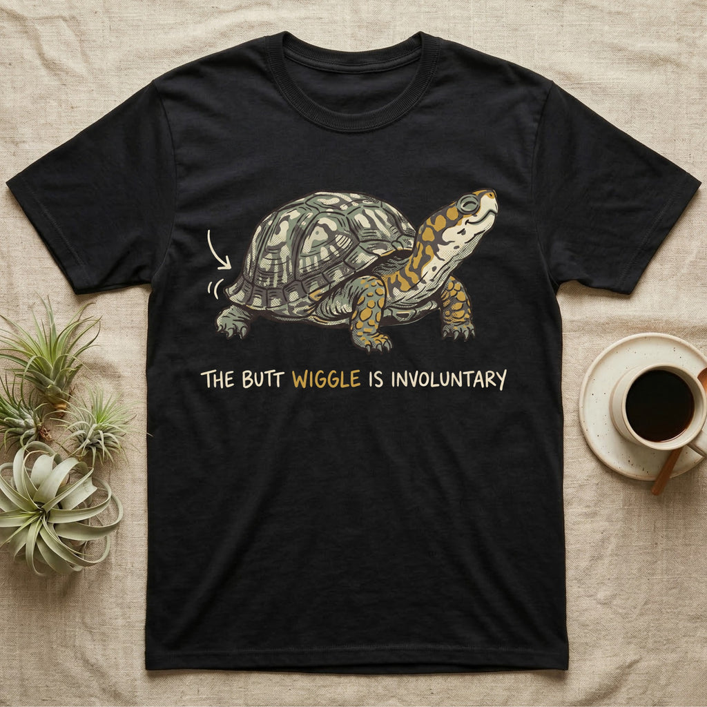 Box Turtle Wiggle T-Shirt in Black — Retro-illustration of a box turtle mid shell-scratch with a hand-drawn arrow at its wiggling rear and a deadpan marker caption.