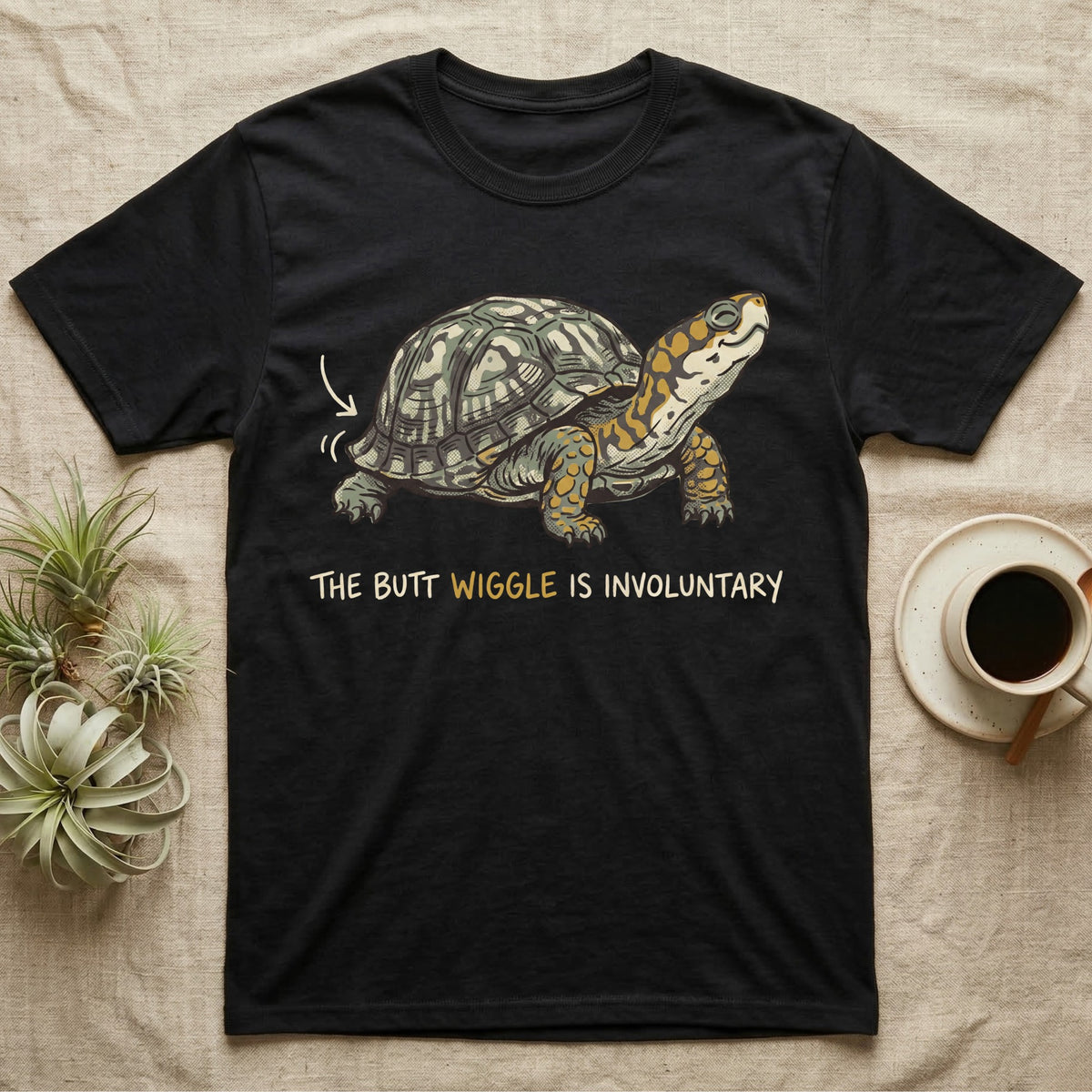 Box Turtle Wiggle T-Shirt in Black — Retro-illustration of a box turtle mid shell-scratch with a hand-drawn arrow at its wiggling rear and a deadpan marker caption.