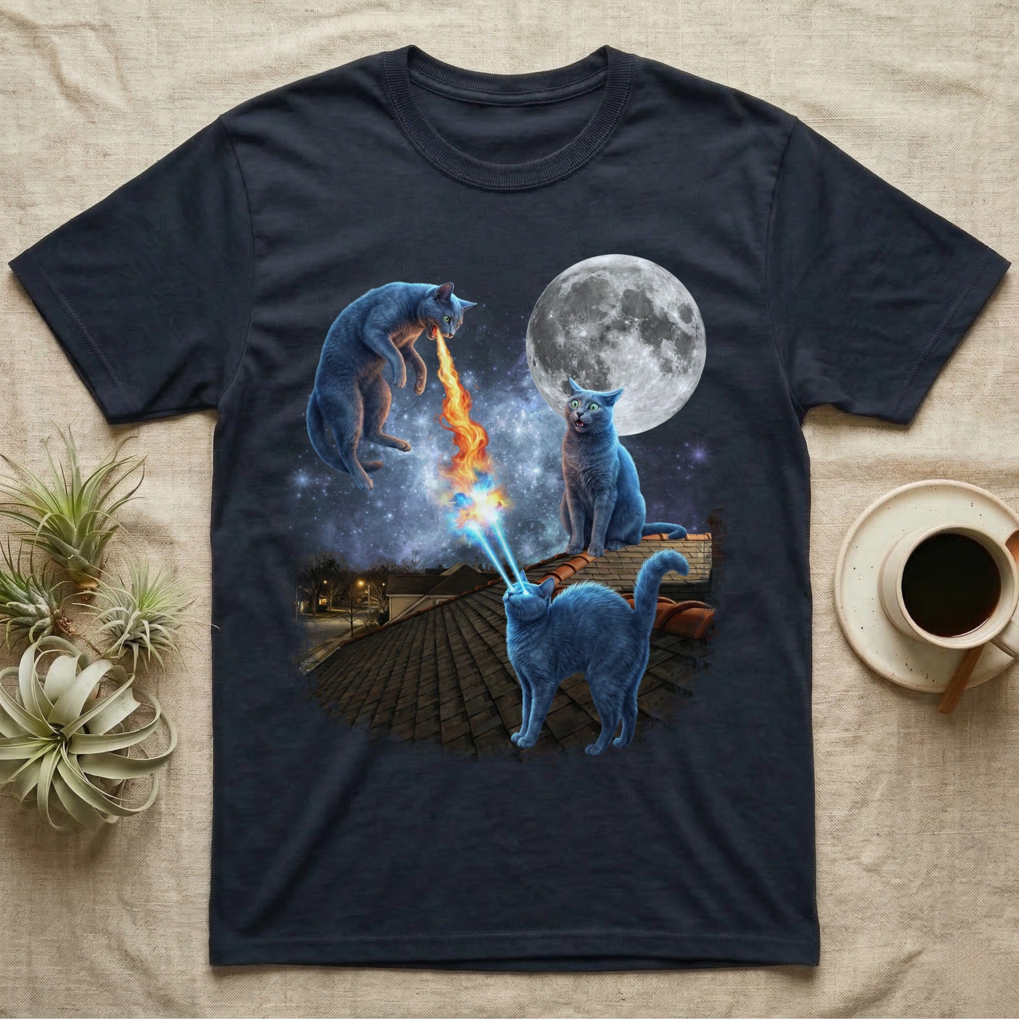 T-shirt featuring three blue cats on a rooftop under a full moon, one spitting fire.