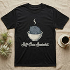 Black t-shirt with a grumpy toad in a bowl, steaming, and "Self-Care Specialist" text.