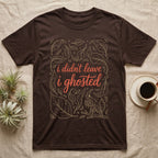 Ghost Mantis Leaf T-Shirt in Dark Chocolate — Tan outline dead leaves and a hidden ghost mantis around coral script reading i didn't leave, i ghosted.
