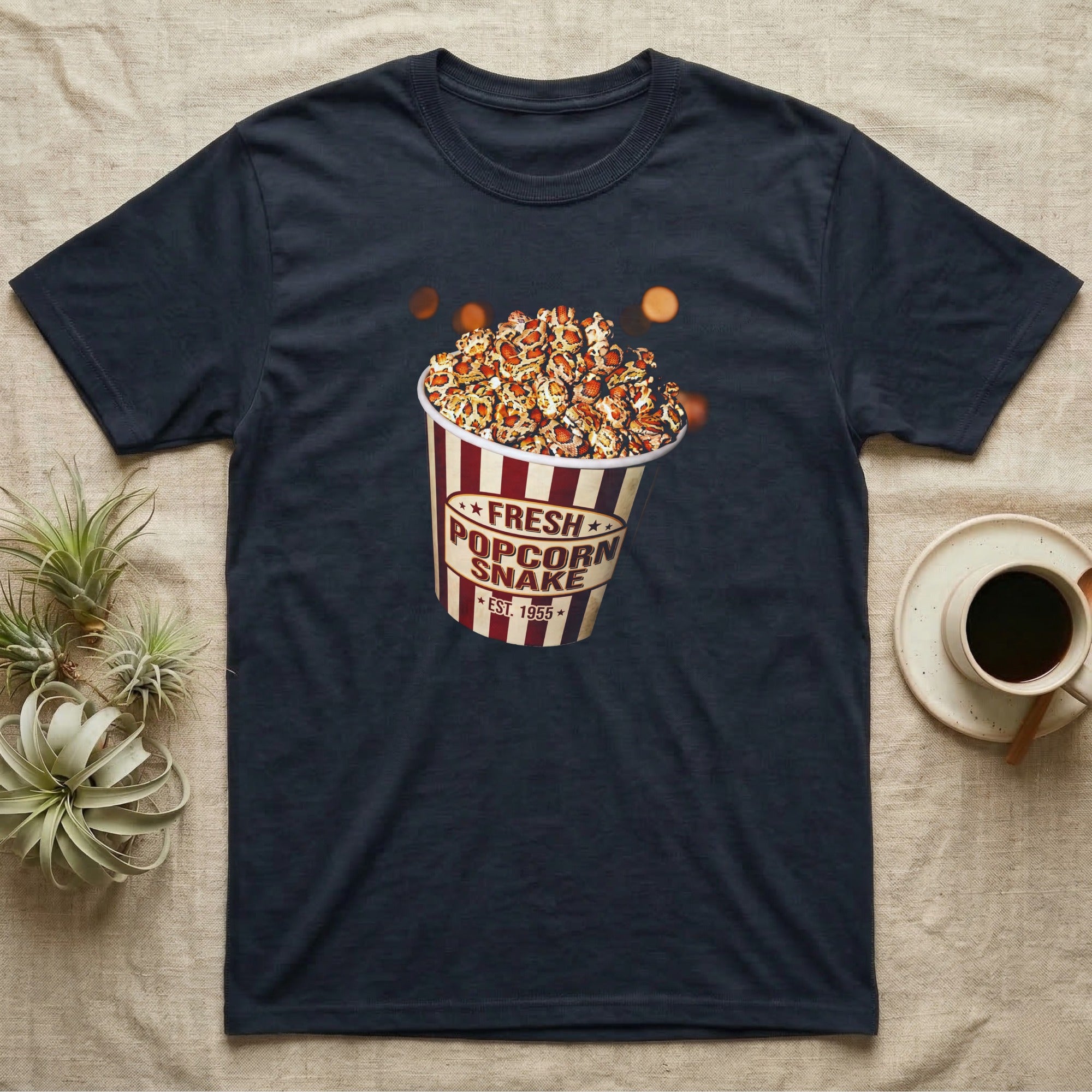 Corn Snake Popcorn Bucket T-Shirt in Navy — Vintage striped cinema popcorn bucket labelled Fresh Popcorn Snake, overflowing with kernels patterned like corn snake scales.