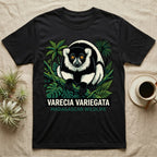 Black t-shirt with a varecia variegata lemur illustration surrounded by tropical leaves.