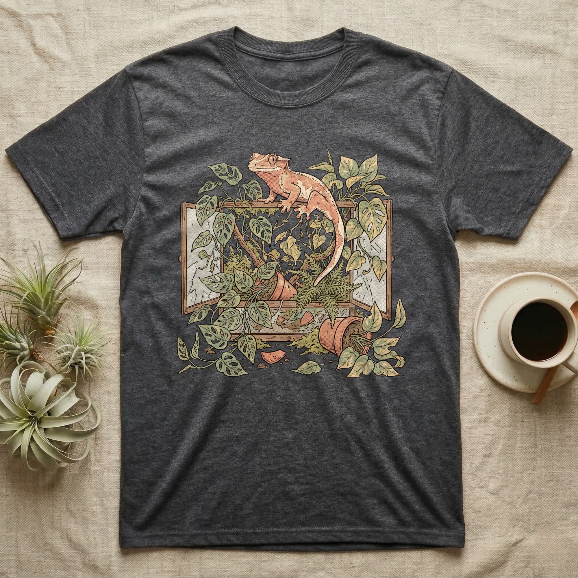Bioactive Crested Gecko T-Shirt in Dark Heather — Botanical illustration of a smug crested gecko perched atop a lush overgrown planted vivarium spilling vines.