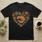 Black t-shirt with a heart-shaped graphic of a gecko among desert plants and crystals.