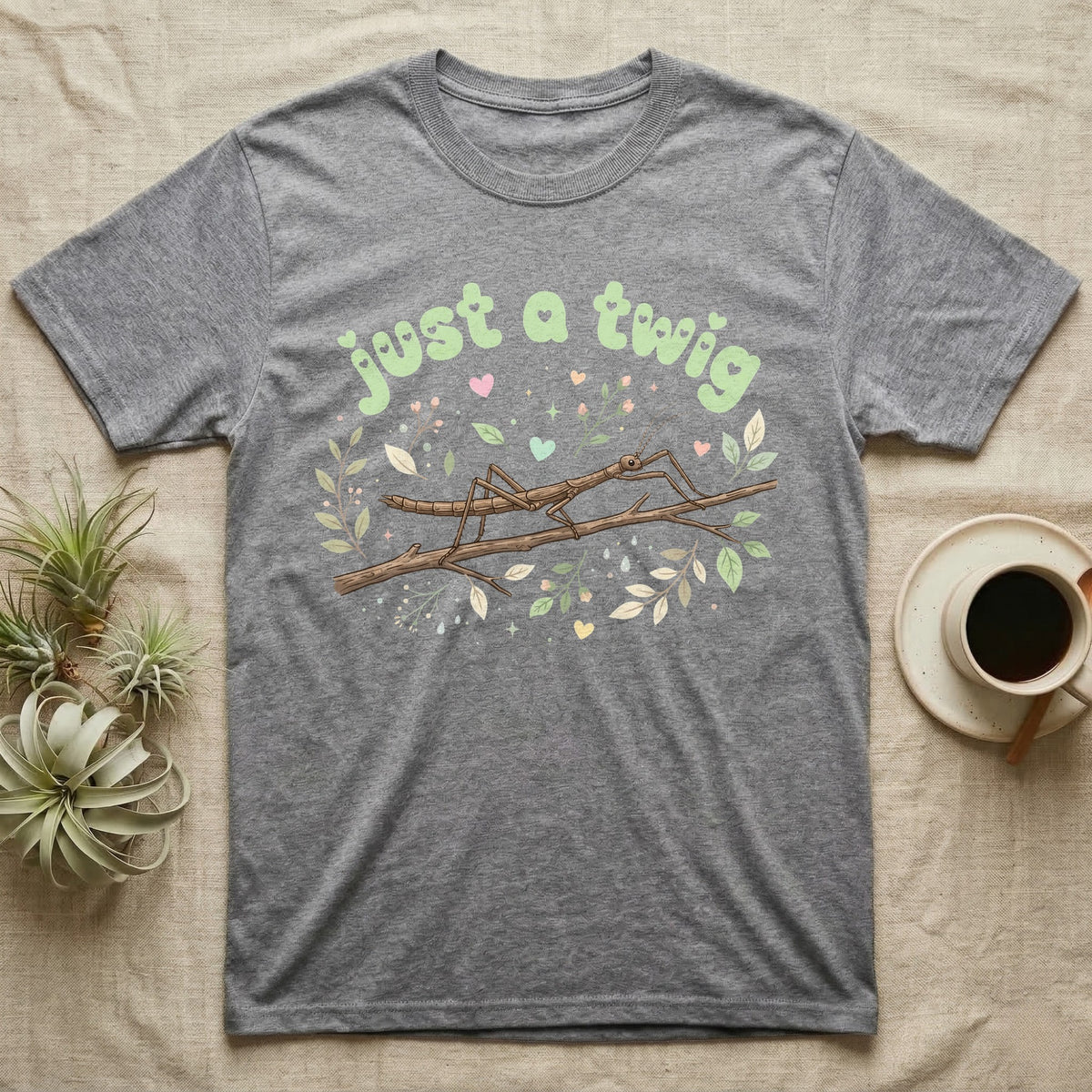 Stick Insect Softie T-Shirt in Sport Grey — Camouflaged stick insect on a branch under pastel bubble text "just a twig" with tiny hearts.
