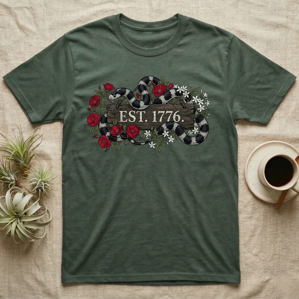 Kingsnake Floral 1776 T-Shirt in Military Green — Black-and-white California kingsnake woven through roses and jasmine around a wooden sign reading Est. 1776.