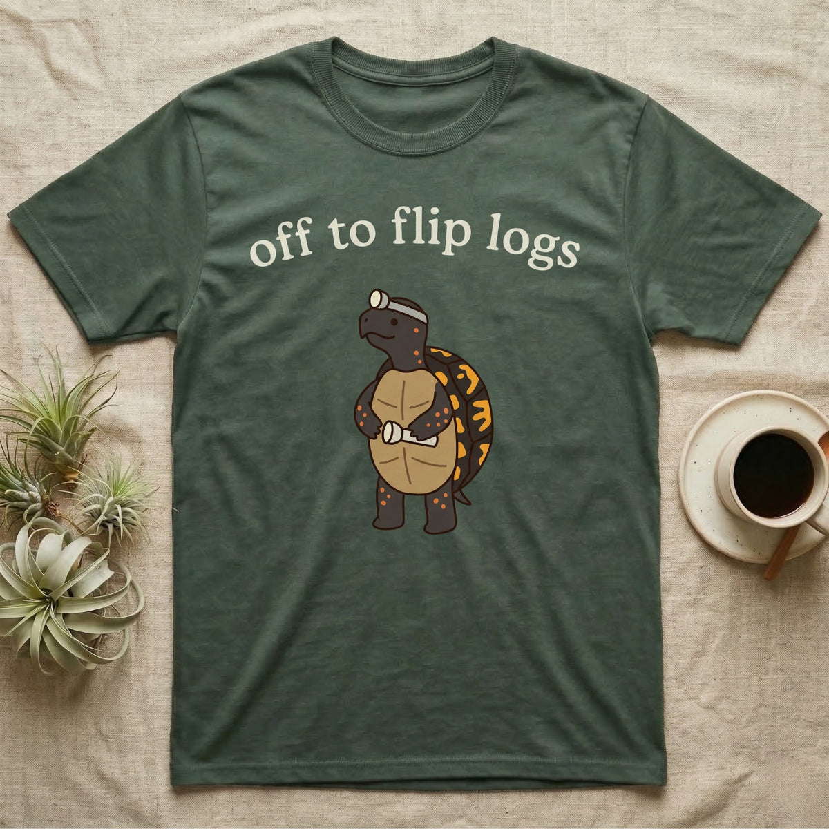 Box Turtle Herping T-Shirt in Military Green — Minimal doodle of an eastern box turtle standing upright in a headlamp holding a flashlight, under the words off to flip logs