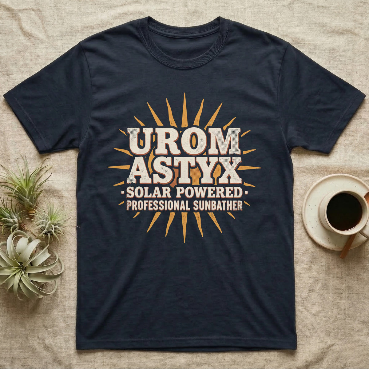 Solar Powered Uromastyx T-Shirt in Navy — Desert-poster wordmark reading "Uromastyx Solar Powered Professional Sunbather" with a small radiating sun motif.