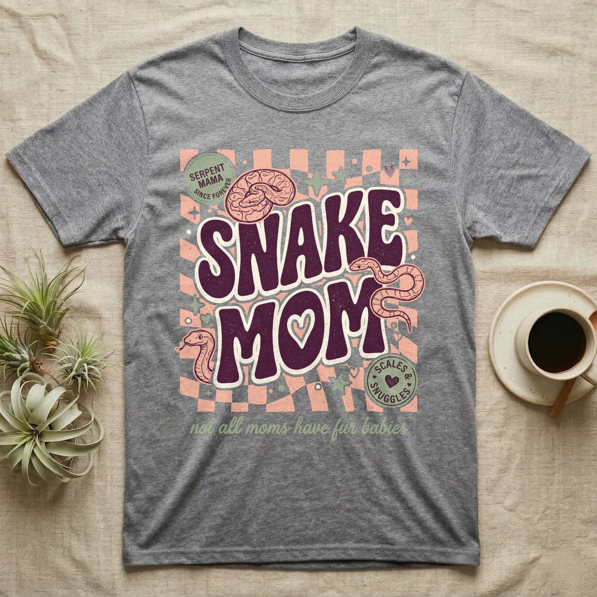 "Serpent Mama" graphic tee with snakes and text "Scales & Snuggles".