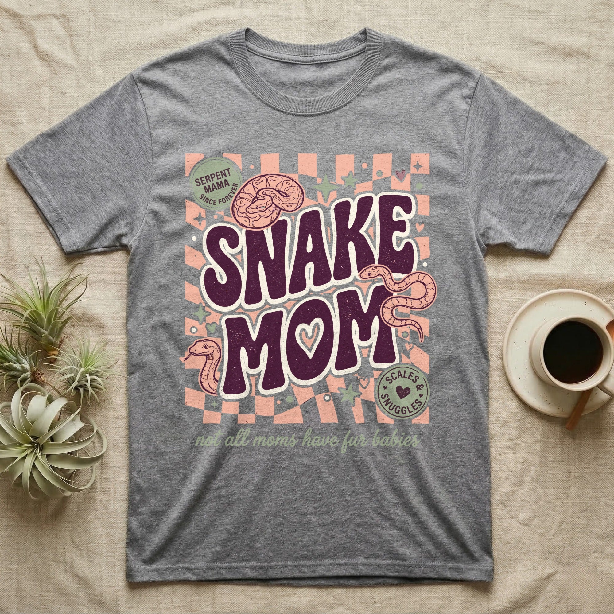 "Serpent Mama" graphic tee with snakes and text "Scales & Snuggles".