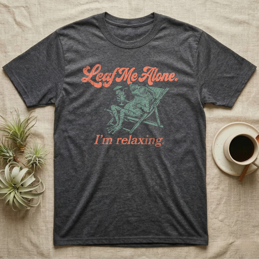Solomon Islands Leaf Frog Chillin T-Shirt in Dark Heather — Illustrated Solomon Islands leaf frog reclining in a beach chair with sunglasses and a cocktail, coral script reading Leaf Me Alone I'm Relaxing.