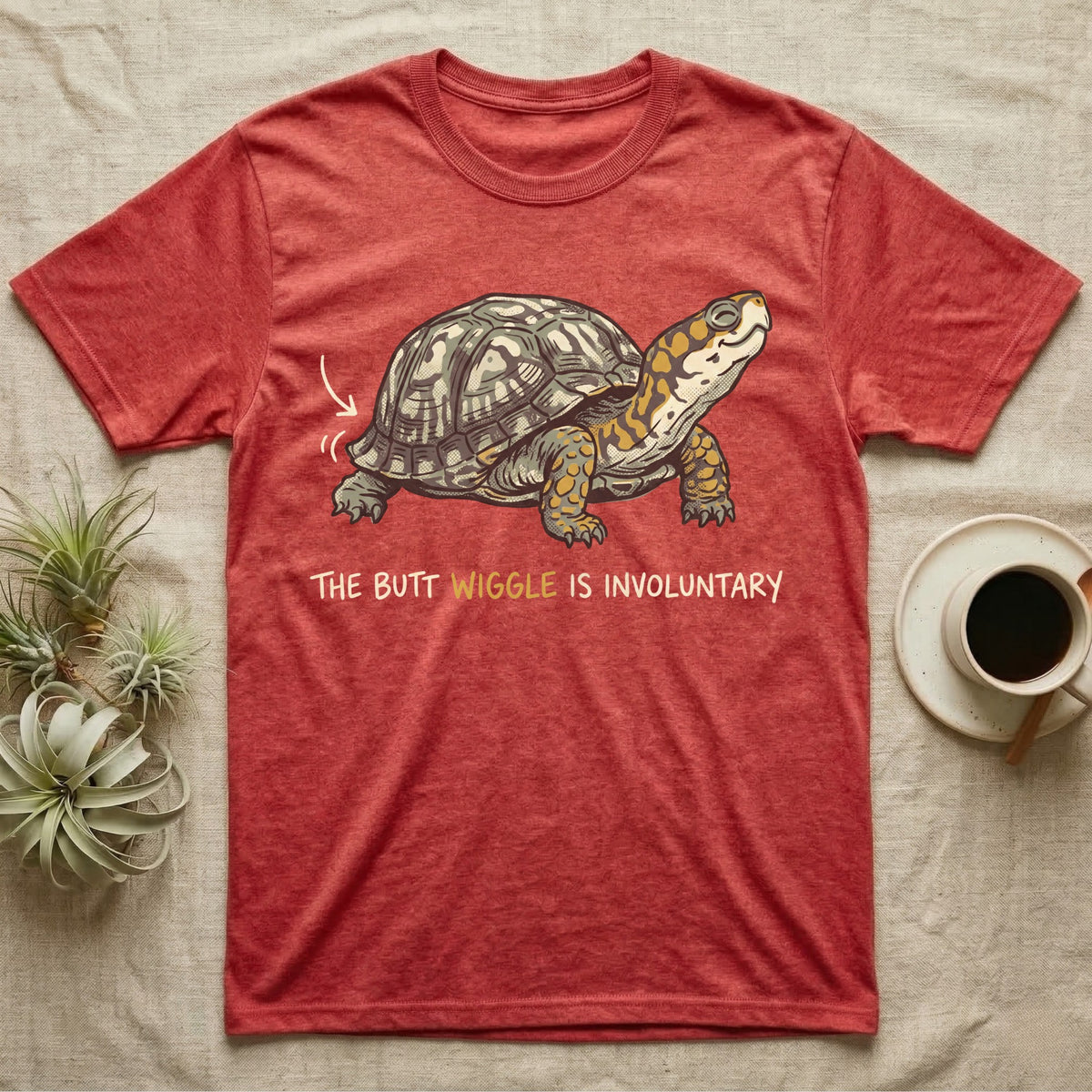 Box Turtle Wiggle T-Shirt in Heather Red — Retro-illustration of a box turtle mid shell-scratch with a hand-drawn arrow at its wiggling rear and a deadpan marker caption.