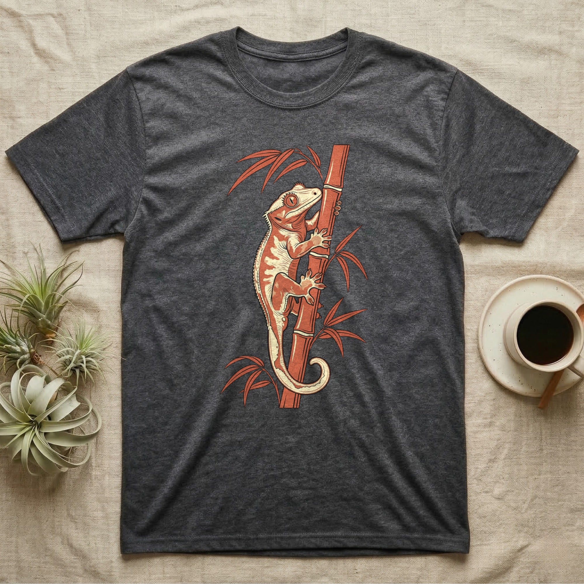 Dark grey t-shirt with a crested gecko climbing a bamboo stalk.