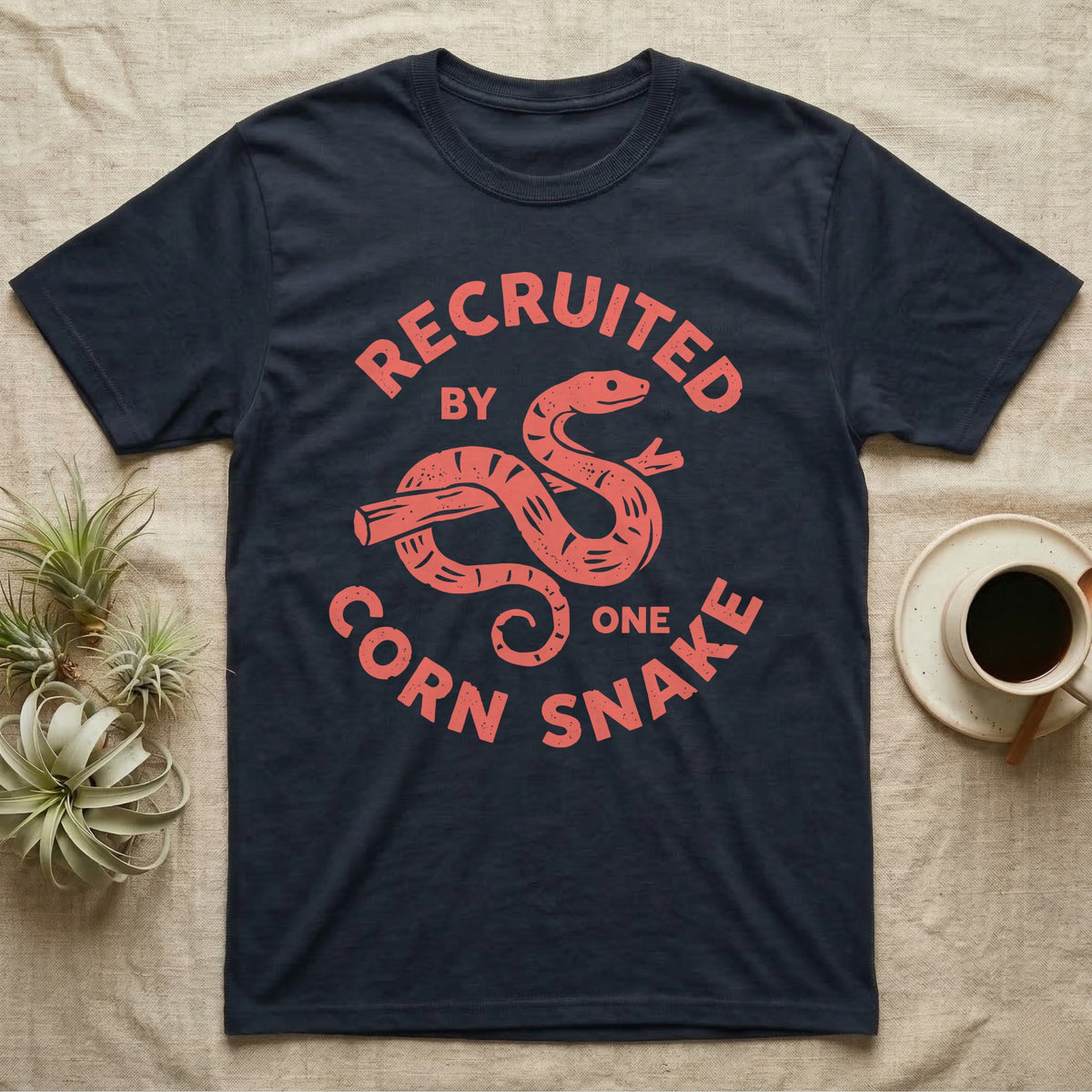 Corn Snake Recruit T-Shirt in Navy — Hand-carved block-print badge of a corn snake on a branch inside ring lettering reading Recruited By One Corn Snake.