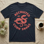Corn Snake Recruit T-Shirt in Navy — Hand-carved block-print badge of a corn snake on a branch inside ring lettering reading Recruited By One Corn Snake.
