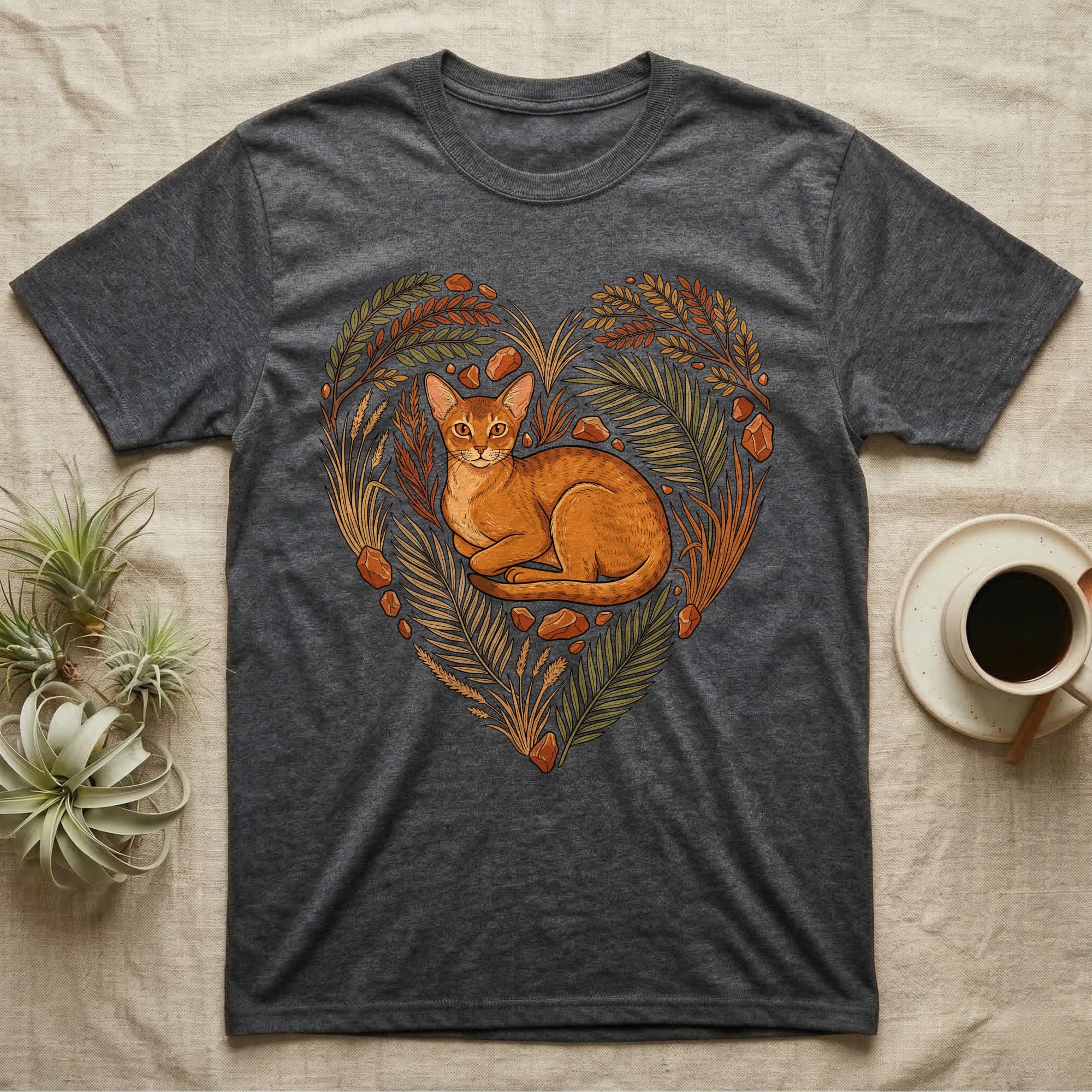 Charcoal t-shirt featuring a ginger cat within a heart of leaves and stones.