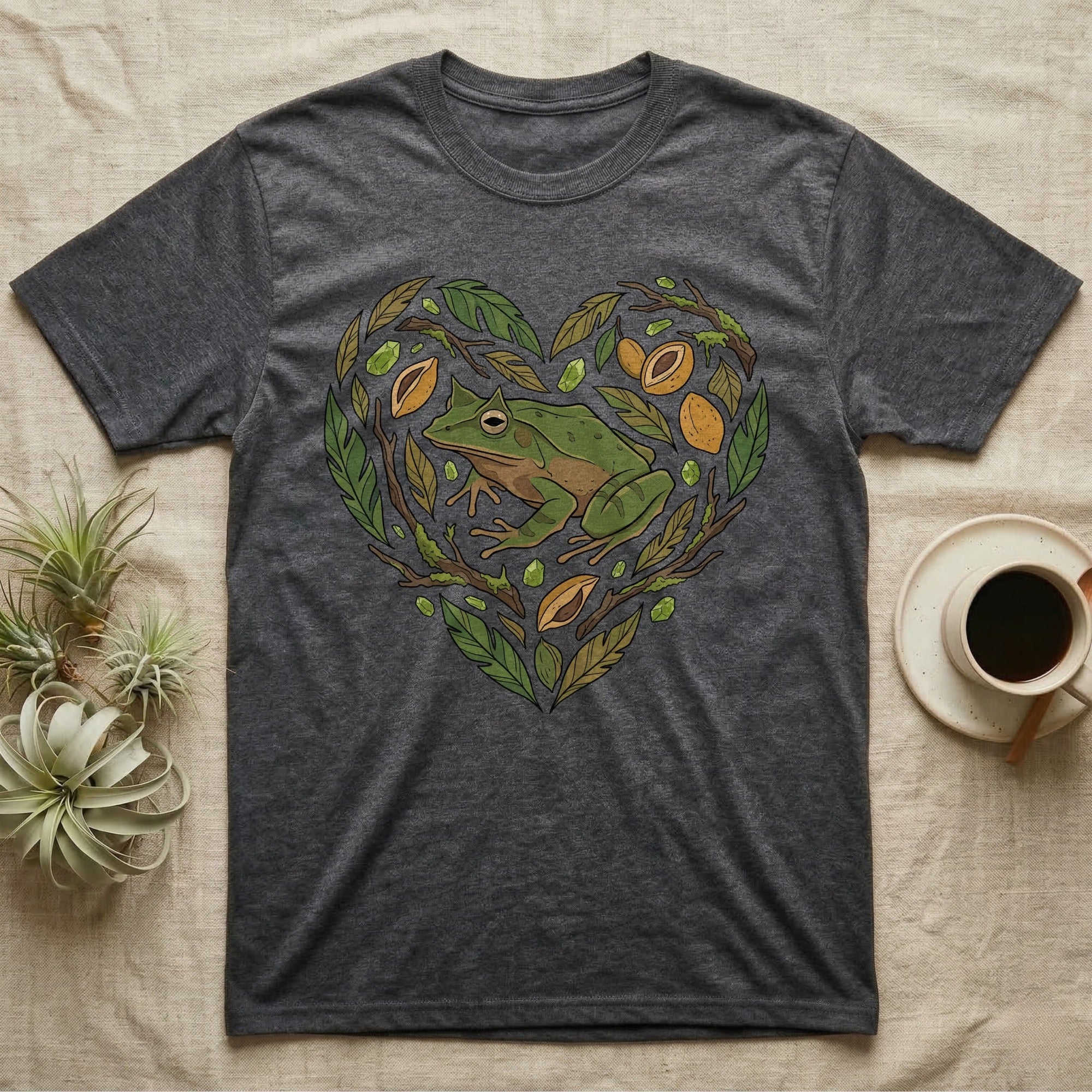 Dark gray t-shirt with a heart-shaped design of a frog and natural elements.