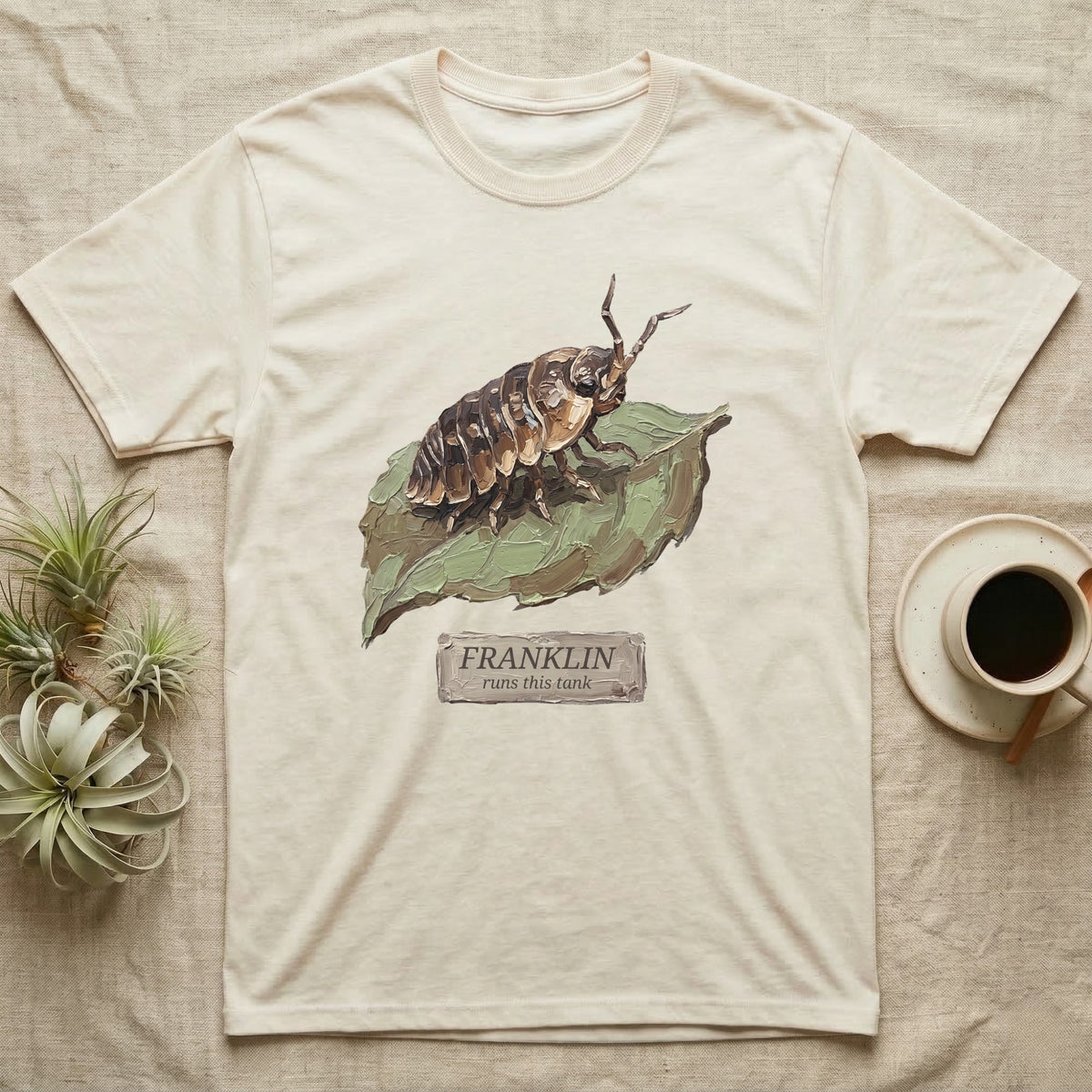 Franklin Isopod Tank T-Shirt in Natural — Impasto oil-painting portrait of an isopod on a leaf with an engraved Franklin name-plate beneath the subject.
