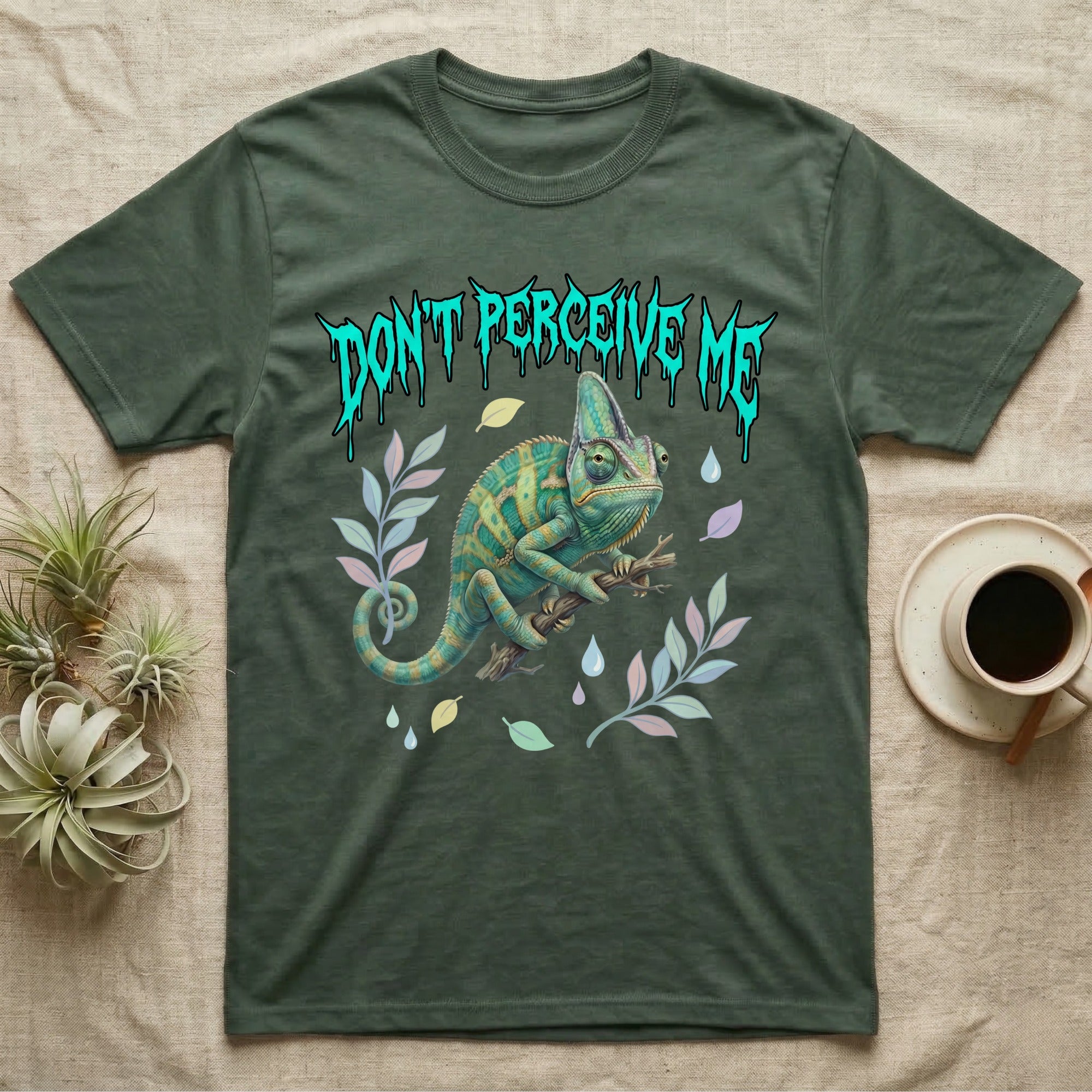 Veiled Chameleon Feral T-Shirt in Military Green — Veiled chameleon on a branch with swivelling eyes under a jagged turquoise metal "DON'T PERCEIVE ME" wordmark.
