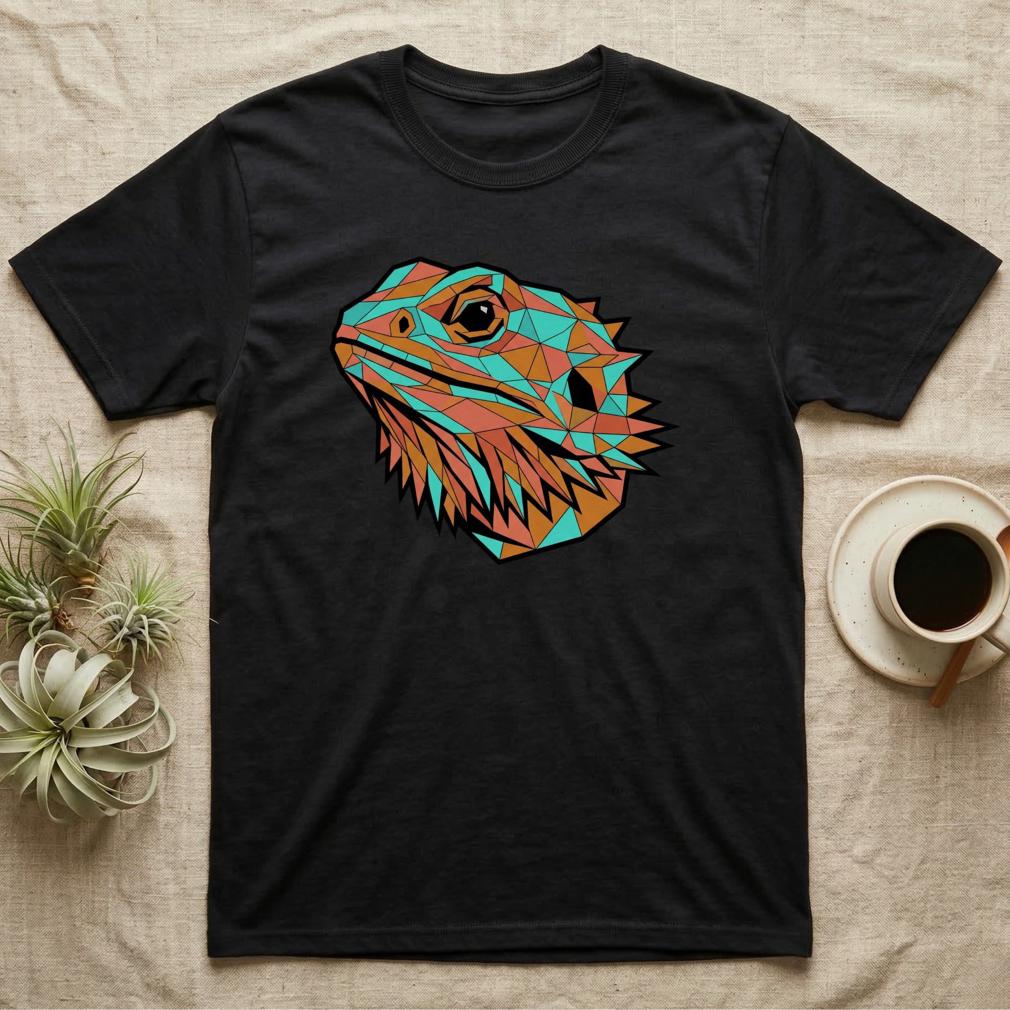 Black t-shirt with a geometric lizard head design in turquoise and orange.