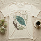 White's Tree Frog Home Range T-Shirt in Natural — Woodcut-style illustration of a White's tree frog resting on a broad wet leaf with reed stems and a crescent moon behind, no on-shirt text.