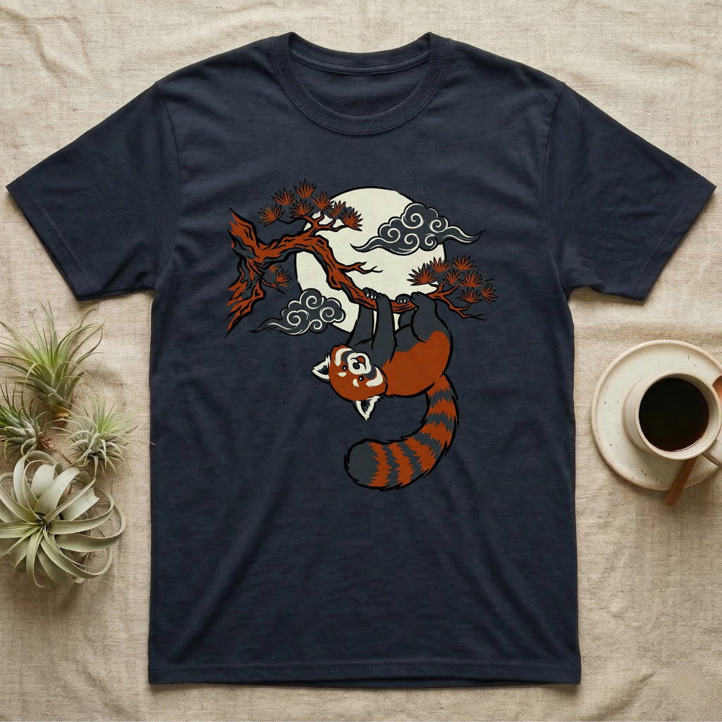 Dark navy t-shirt featuring a red panda hanging from a tree branch with a moon and clouds.