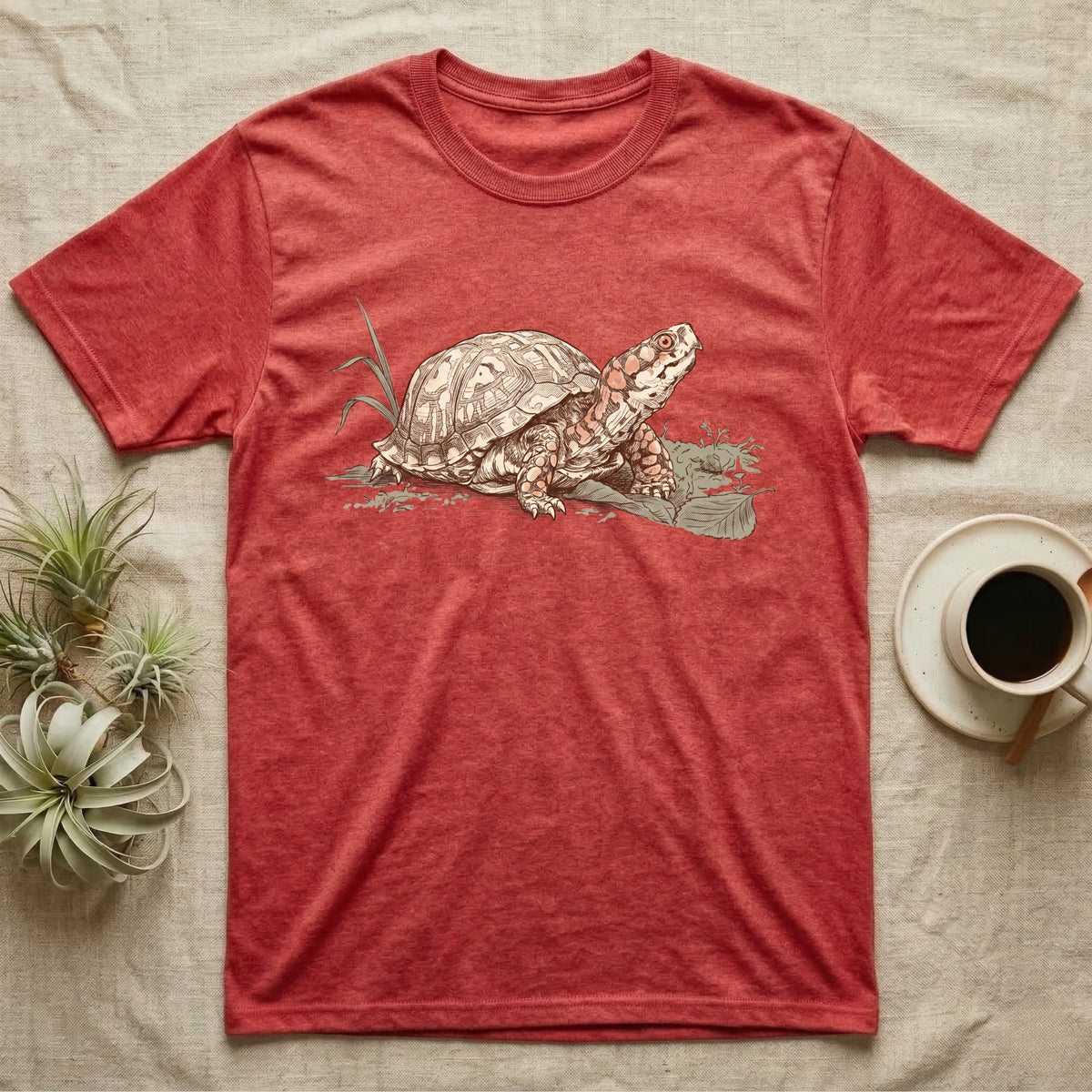 Box Turtle Shell T-Shirt in Heather Red — Naturalist-plate illustration of a box turtle with its shell shown as living body, above a serif welfare creed caption.