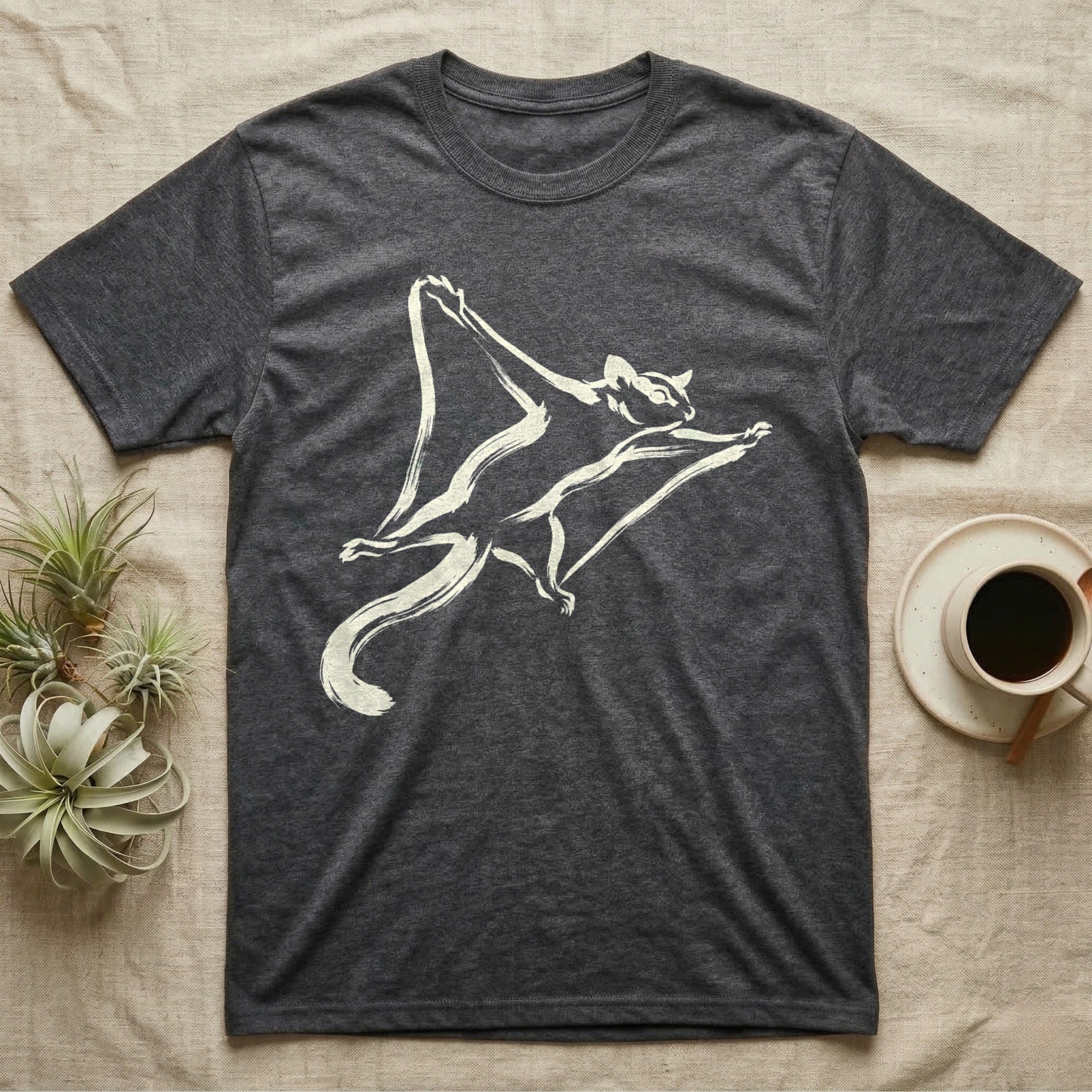 Dark grey t-shirt with a cream flying squirrel graphic and a coffee cup.
