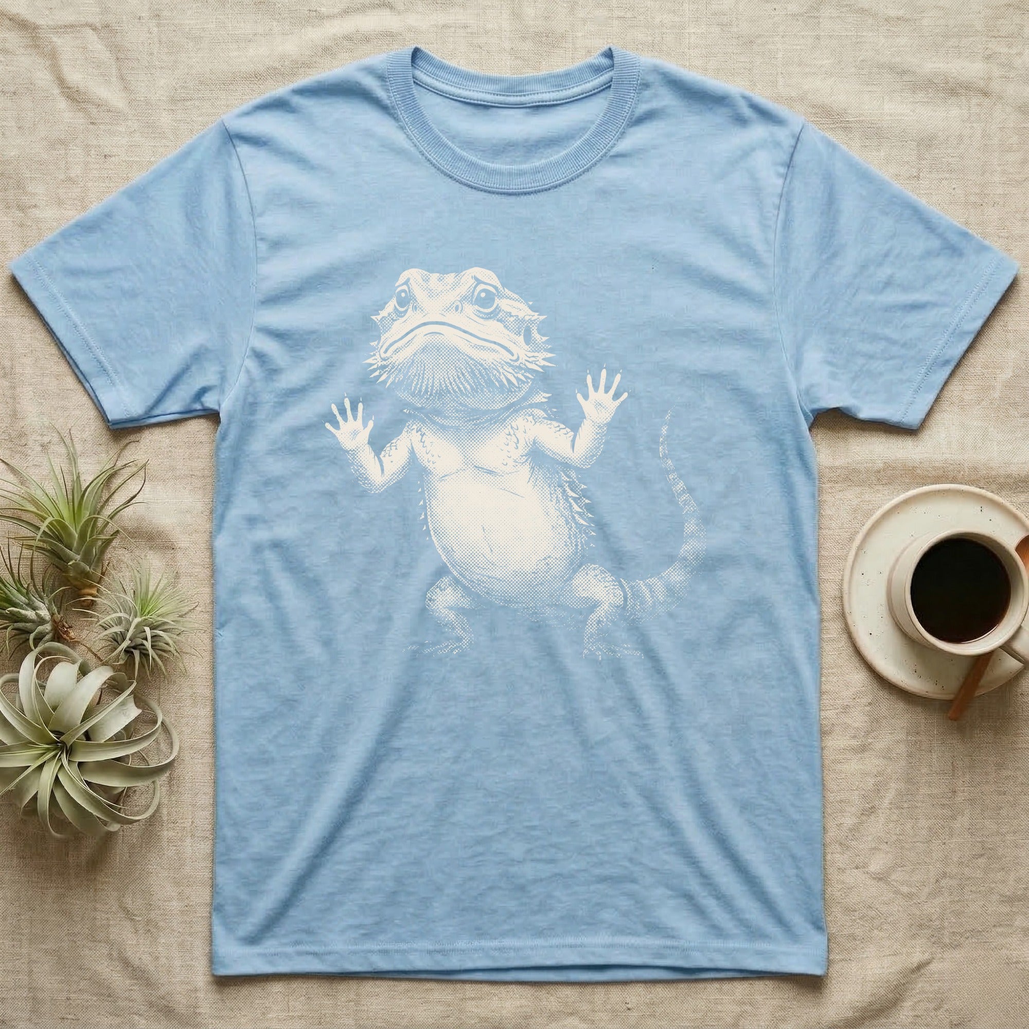 Begging Bearded Dragon T-Shirt in Light Blue — Sad-meme halftone illustration of a bearded dragon standing upright with arms pressed to unseen glass, looking forlorn.