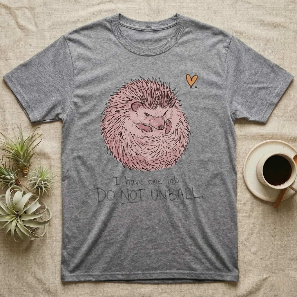Hedgehog Do Not Unball Tee in Sport Grey — Naive-doodle hand-drawn hedgehog curled in a tight defensive ball above a wobble-handwritten "Do Not Unball" label.