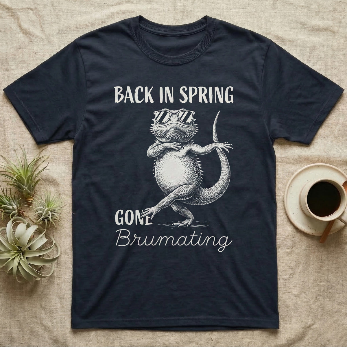 Bearded Dragon Brumating T-Shirt in Navy — Bearded dragon in striped sunglasses doing a dance step, retro text reads Back In Spring, Gone Brumating
