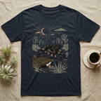 Red-Knee Tarantula Home Range T-Shirt in Navy — Woodcut-style illustration of a Mexican red-knee tarantula at its burrow entrance under a rock slab with desert scrub behind, no on-shirt text.