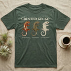 Crested Gecko Morph Chart T-Shirt in Military Green — Impasto painted chart of three crested gecko morphs — harlequin, pinstripe and dalmatian — labelled beneath each gecko.