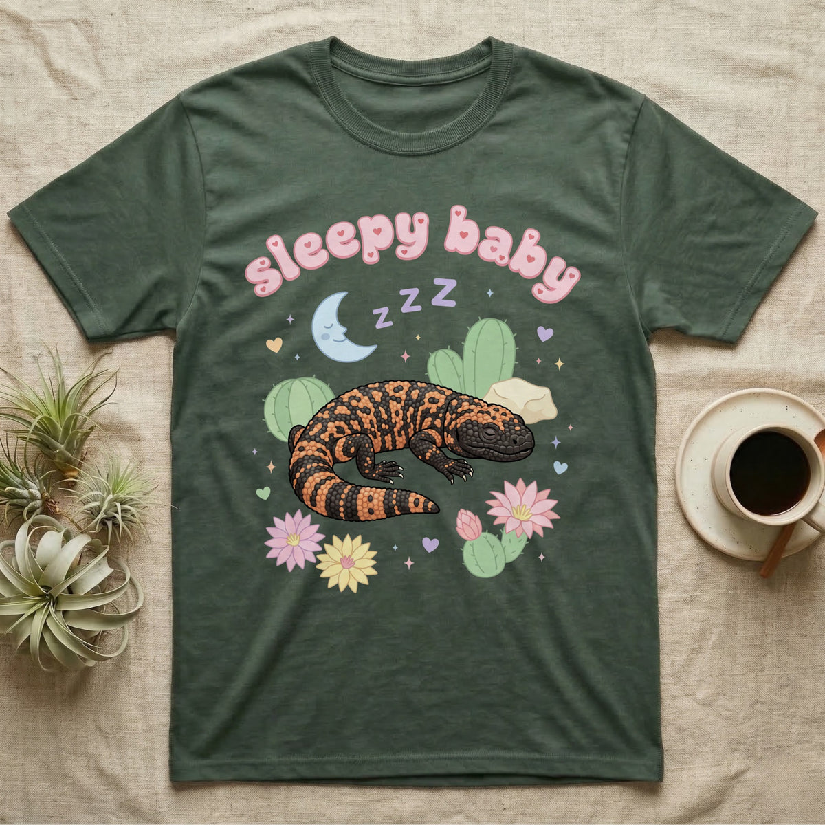 Gila Monster Baby T-Shirt in Military Green — Pastel Gila monster with sleepy eyes, crescent moon and Z Z Z, puffy salmon bubble wordmark "sleepy baby" above.