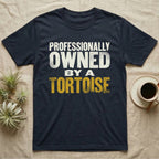 Owned By A Tortoise T-Shirt in Navy — Distressed woodtype wordmark reading professionally owned by a tortoise in a bold two-tier lockup, text only.