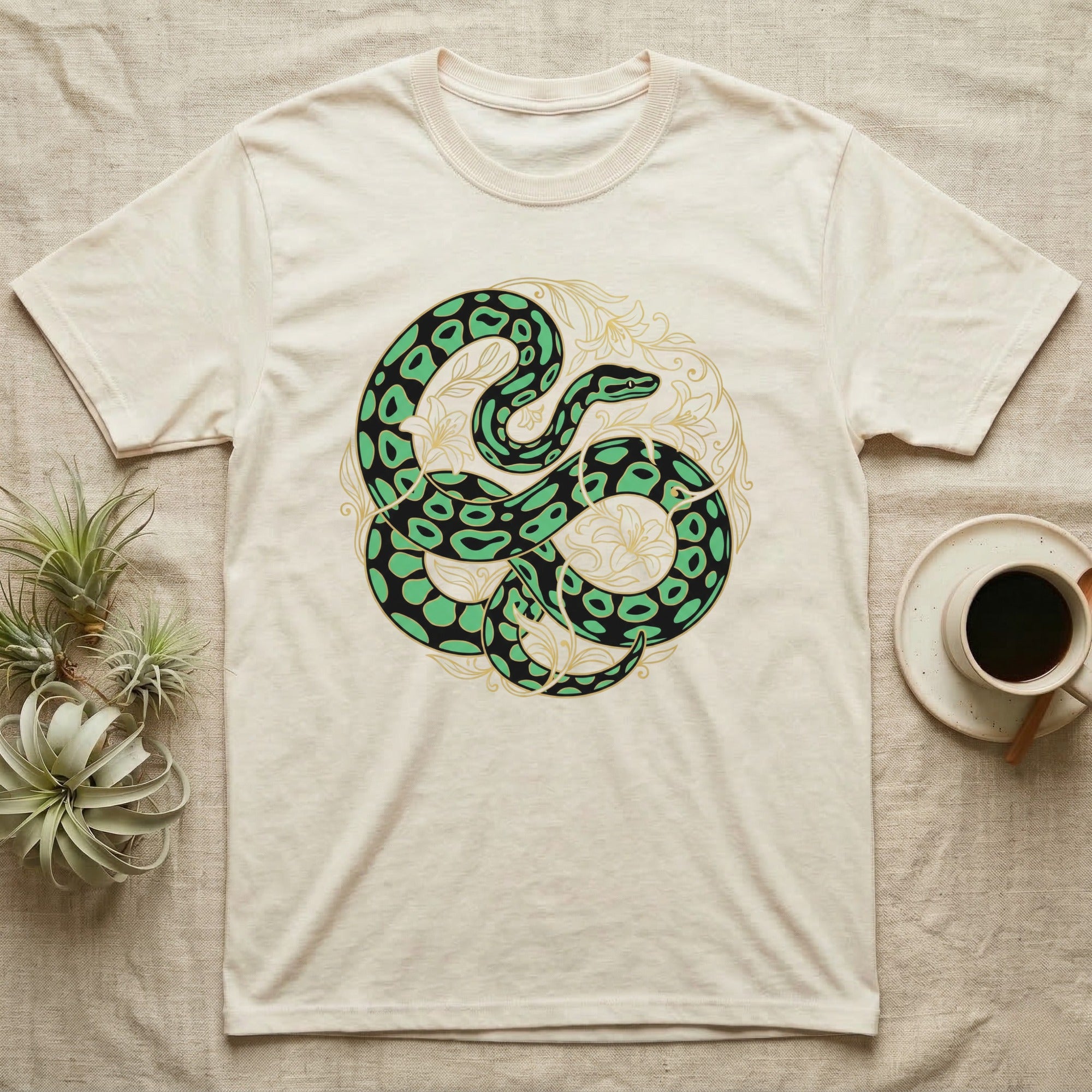 Cream t-shirt with green snake and gold floral design.