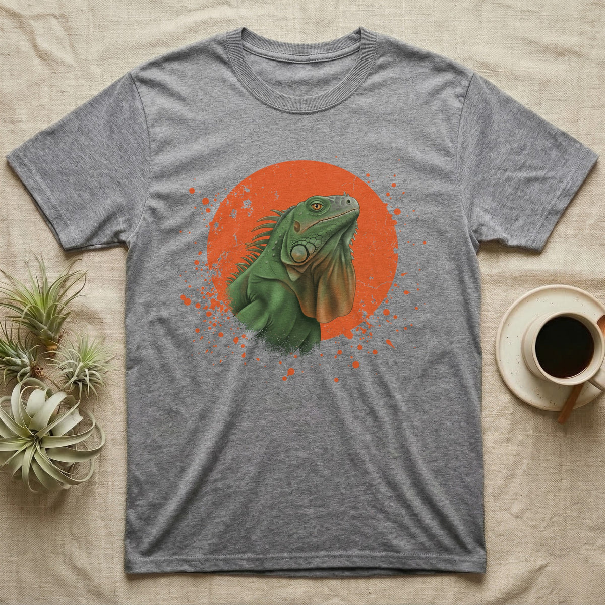 Green Iguana Stink Face T-Shirt in Sport Grey — Distressed vintage-style illustration of a green iguana with its dewlap fully dropped and chin lifted, on an orange disc.